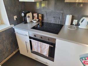 a kitchen with a stove and a counter top at Domek Lipek in Ustroń