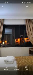a bedroom with a window with a view of a city at STAYCITY OTEL in Altındağ