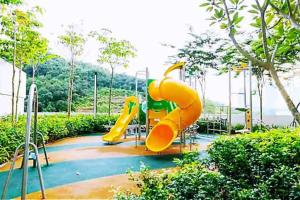 a playground with a slide in a park at Legoland JB AGhome Medini 3room8pax bukit indah in Nusajaya