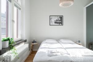 a white bedroom with a bed and a window at "Keskustori" - Renovated 1BR Apartment with Sauna at the BEST Location, Hosted by 2ndhomes in Tampere