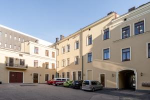 a row of buildings with cars parked in a parking lot at "Keskustori" - Renovated 1BR Apartment with Sauna at the BEST Location, Hosted by 2ndhomes in Tampere