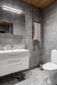 a bathroom with a white sink and a toilet at "Keskustori" - Renovated 1BR Apartment with Sauna at the BEST Location, Hosted by 2ndhomes in Tampere +18 photos