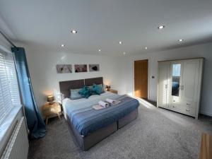 a bedroom with a bed with twoeddy bears on it at Stylish Modern Home with Parking Enclosed Garden in Holyhead