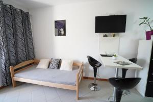 a small room with a bed and a table at IVA studio-apartment in Kladovo