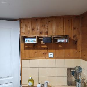 a kitchen with wooden cabinets and boxes on the wall at L'HYPERCENTRE Bis in Clermont-Ferrand