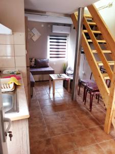 a kitchen with a staircase and a living room at Apartmani Gaga in Đenovići