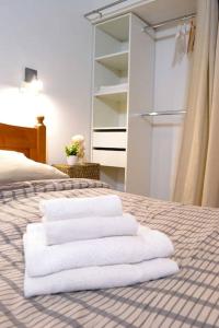 une pile de serviettes assises au-dessus d'un lit dans l'établissement Apprt Top Center / 2 Chambres / 2 Salles de bain., à Montpellier