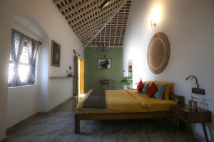 a bedroom with a large bed in a room at Craft Hostels in Anjuna