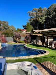 a swimming pool in a yard next to a house at Snow View Holiday Units in Mount Beauty