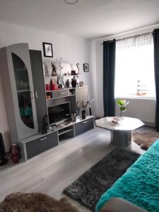 a living room with a large mirror and a table at Apartament Geo in Nehoiu