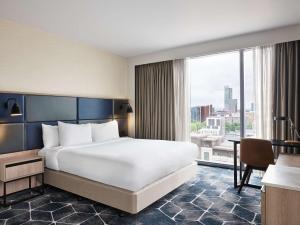 a hotel room with a bed and a large window at Hyatt Regency Manchester in Manchester