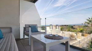 a living room with a table and chairs on a balcony at Panorama Beach - Blue Horizon in Torrox Costa
