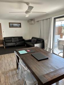 a living room with a table and a couch at Snow View Holiday Units in Mount Beauty