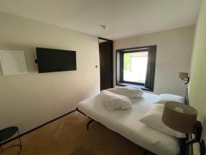 a hotel room with two beds and a flat screen tv at Warth52-W52 Apartments in Warth am Arlberg