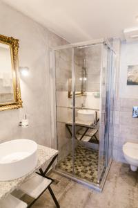 a bathroom with a shower and a sink and a toilet at Villa Helvetia in Târgu-Mureş