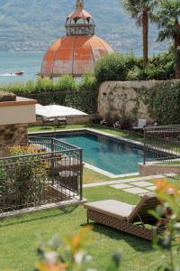 a swimming pool in a yard with a dome at MUSA Lago di Como in Sala Comacina