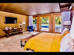 a bedroom with a bed and a desk and a television at Srvittinivillas Cn-ll66 Great Villa Good Location Casa de Campo Resort Villa in La Romana