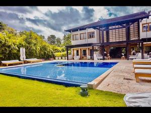 a house with a swimming pool in front of a house at Srvittinivillas Cn-ll66 Great Villa Good Location Casa de Campo Resort Villa in La Romana