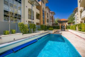 a swimming pool in front of a building at ROYA6320 - Royal Respite in Perth