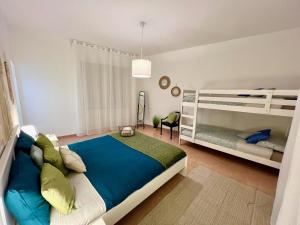 a bedroom with a large bed and bunk beds at Stay in Malpensa in Case Nuove