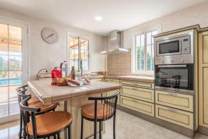 a kitchen with a table with chairs and a microwave at Villa Sayana in Palma de Mallorca