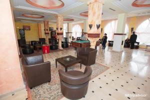 a lobby with leather chairs and a pool table at Hotel Golf Residence in Hammam Sousse