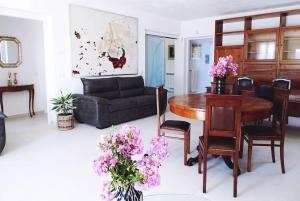 a living room with a couch and a table and flowers at Villa Luigia in Gerenzano