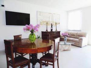 a living room with a table with a vase of flowers on it at Villa Luigia in Gerenzano