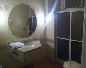 a bathroom with a sink and a shower with a mirror at Jumbo Hotel (Adults Only) in Rio de Janeiro