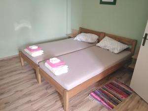 a bed with three folded towels on top of it at B&B Majhen in Kopačevo +34 photos
