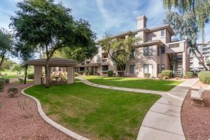 an exterior view of a house with a lawn and a gazebo at The Nines Scottsdale in Scottsdale