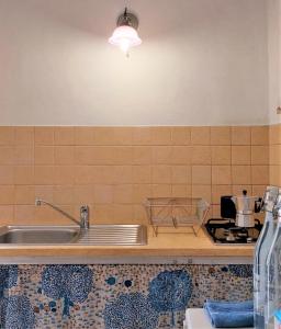 a kitchen counter with a sink and a stove at Bed & Breakfast Porta d'Oriente in Brindisi