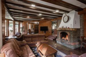 a living room with a couch and a fireplace at Маєток Ліс і Гори in Bukovel