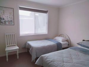 Ένα ή περισσότερα κρεβάτια σε δωμάτιο στο Comfortable three bedroom home close to the beach