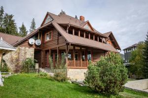 una casa de madera con techo de gambrel en Маєток Ліс і Гори en Bukovel