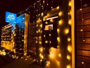 a building with lights on the side of it at Milaano Orchids, Service Villa, Kammana Mananthavady in Wayanad