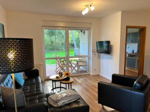 a living room with a couch and a table at Ferienwohnung Sünnsied in Zinnowitz