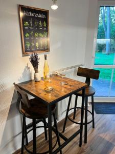 a dining room table with two chairs and wine glasses at Ferienwohnung Sünnsied in Zinnowitz