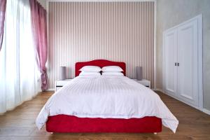 a bedroom with a red and white bed with two pillows at Appartamento a uso turistico in Viterbo