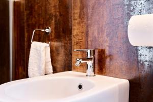 a bathroom with a white sink and a towel at Appartamento a uso turistico in Viterbo +33 photos