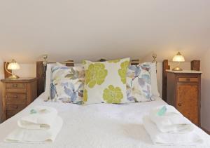 a bedroom with a bed with two towels on it at The Carters Loft in Badingham