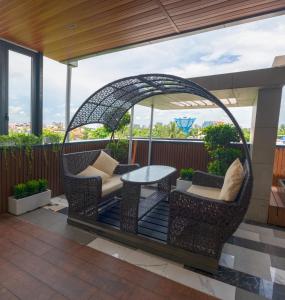 a gazebo with chairs and a table on a patio at Brio Hotel in Kolkata