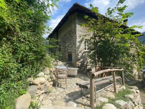 a stone house with a bath tub in front of it at Mountain Cabin Valsesia Appartement Stella in Varallo