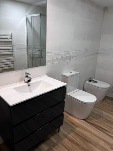 a bathroom with a sink and a toilet and a mirror at Modern Apartment by the Airport IFEMA - 1 Bedroom in Madrid
