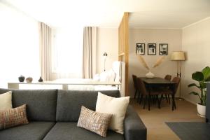 a living room with a couch and a table at Lamira Serviced Apartments Zurich City in Zurich