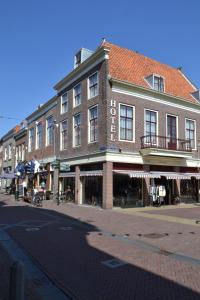 a large brick building on a city street at Fletcher Hotel De Zalm in Brielle