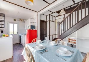 a kitchen with a table with a blue table cloth at Beach House in Southwold