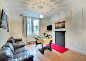 a living room with a couch and a table in front of a fireplace at Arthog Hall Farm in Arthog