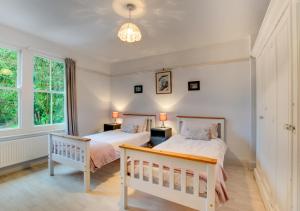 A bed or beds in a room at Arthog Hall Farm