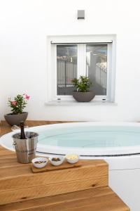 a bath tub with bowls of food on a wooden table at Peonia Boutique Apartments in Palermo